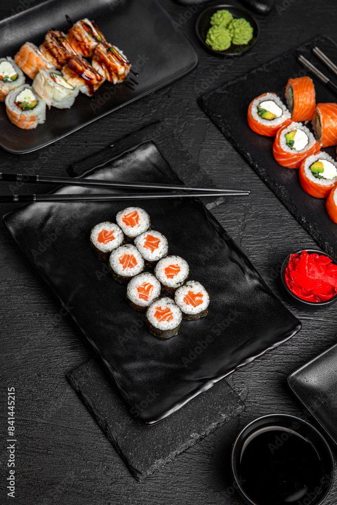 Sushi set composition on black background. The Art of Japanese Cuisine. Food photography for menu and sushi bar decoration Sushi set composition on black background. The Art of Japanese Cuisine. Food photography for menu and sushi bar decoration