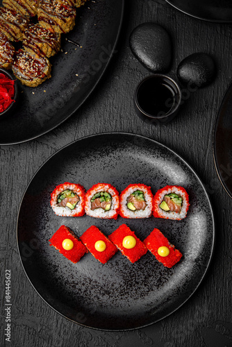 Sushi set composition on black background. The Art of Japanese Cuisine. Food photography for menu and sushi bar decoration