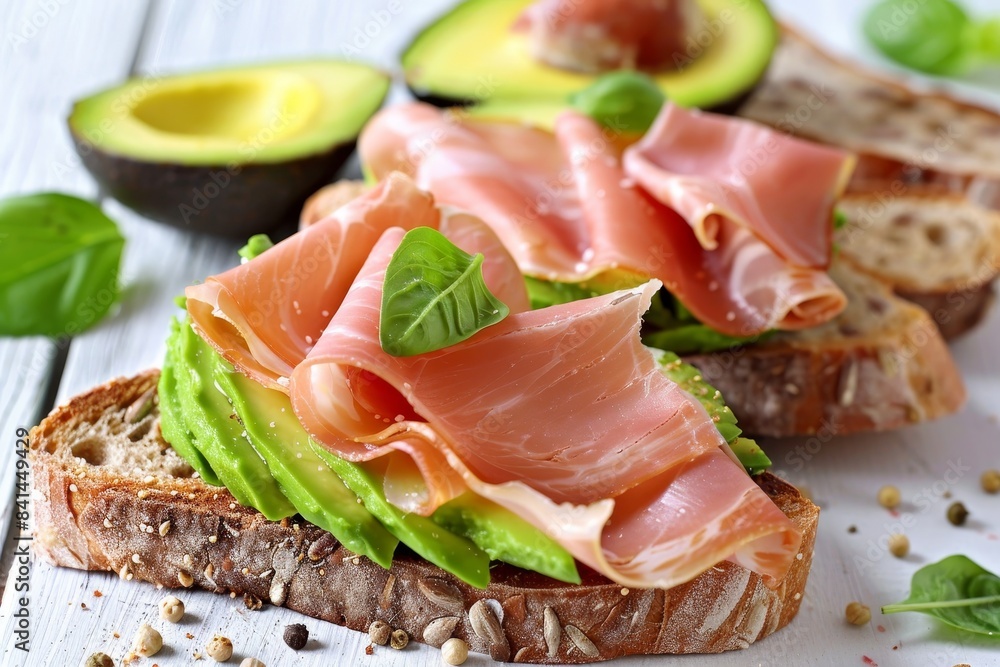 Turkey ham bruschetta on avocado slices on white background for elegant presentation Turkey ham bruschetta on avocado slices on white background for elegant presentation