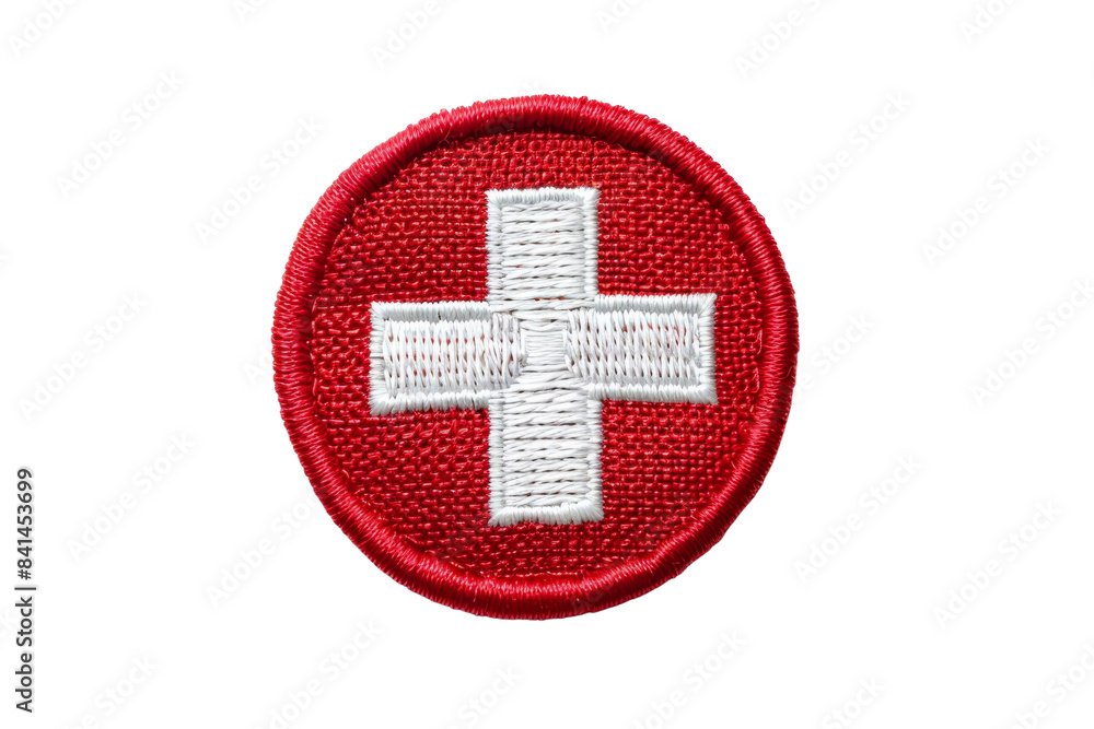 Obraz premium Swiss flag patch isolated on transparent background. Red circle badge with white cross symbol for national identity and travel. Embroidered design.
