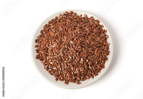 Top view of Brown flax seeds on white plate isolated on white background. Brown Flax Seed is rich in nutrients such as dietary fiber and essential fatty acids that are beneficial to the body.