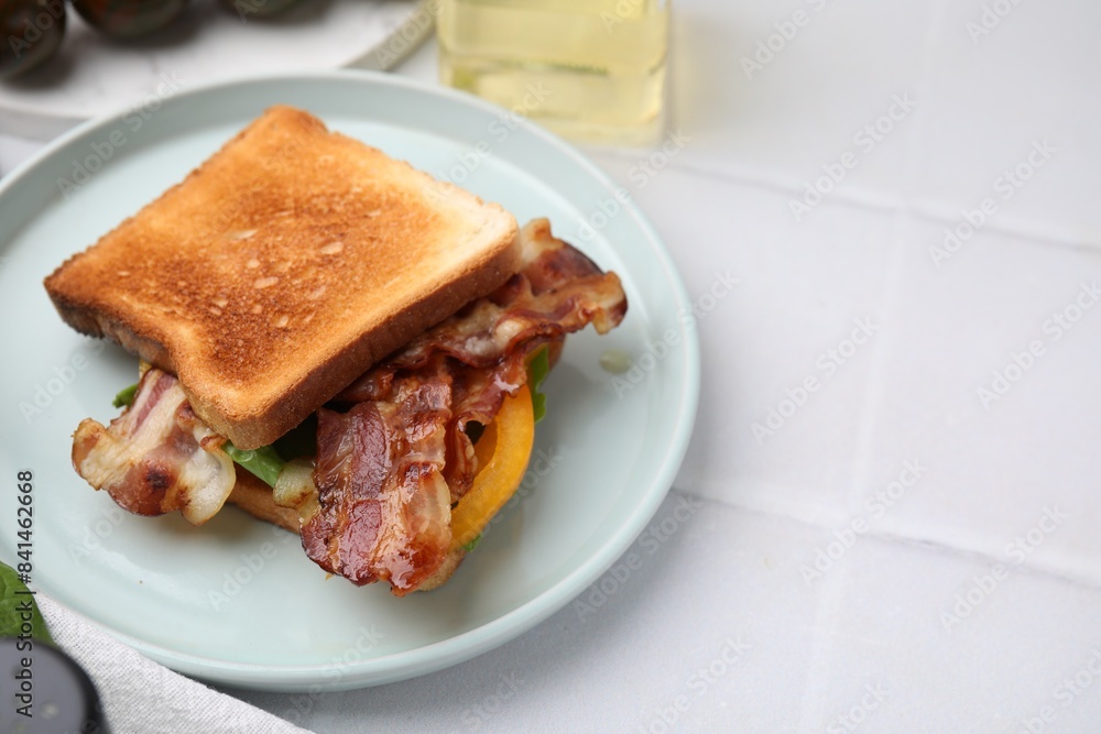 Tasty sandwich with bacon and bell pepper on white tiled table, space for text Tasty sandwich with bacon and bell pepper on white tiled table, space for text