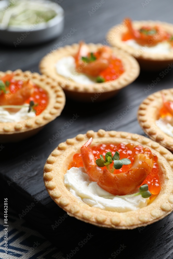 Delicious canapes with shrimps, red caviar and cream cheese on dark table, closeup Delicious canapes with shrimps, red caviar and cream cheese on dark table, closeup