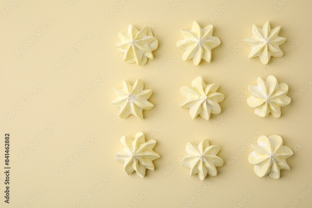 Delicious meringue cookies on beige background, flat lay. Space for text Delicious meringue cookies on beige background, flat lay. Space for text