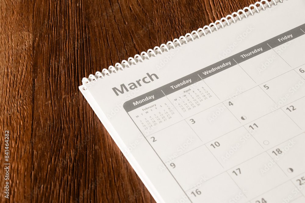 White calendar of the month of March on a wooden background. Planning, goal setting, agenda, planner, organization and time management concept. White calendar of the month of March on a wooden background. Planning, goal setting, agenda, planner, organization and time management concept.