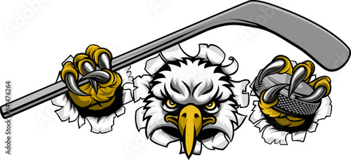 An eagle ice hockey player animal sports mascot holding a hockey stick and puck