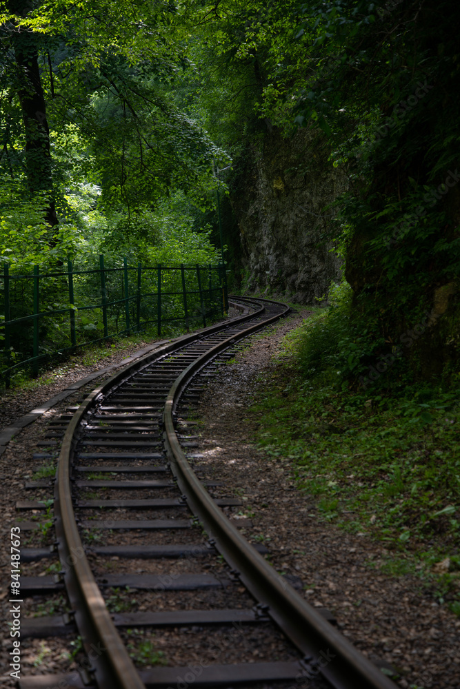 Early morning. Old railway in a mountain forest. Early morning. Old railway in a mountain forest.