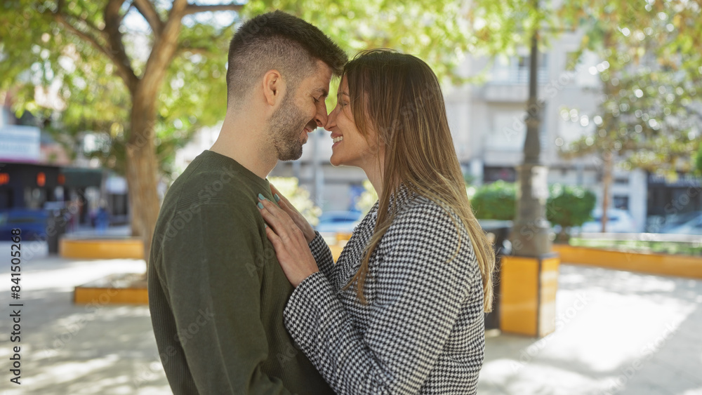 Intimate couple embracing in love on a city street with affection and togetherness