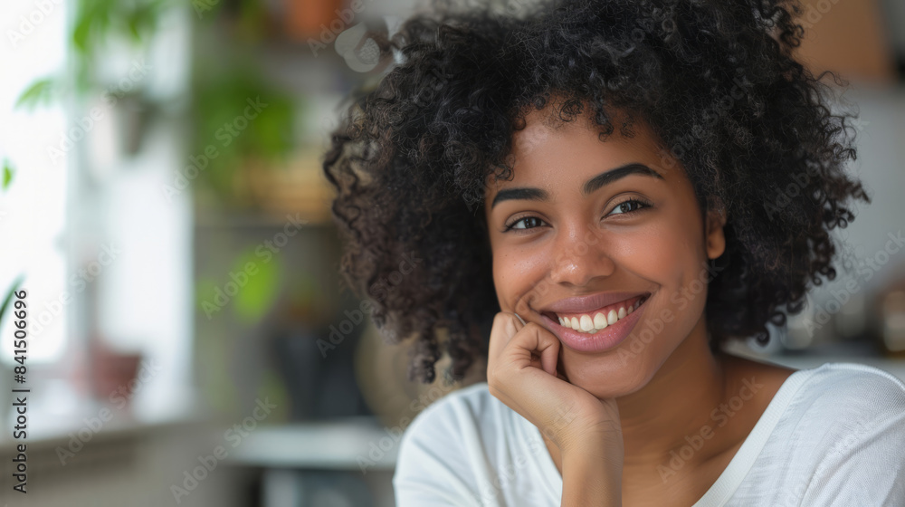Smiling woman with hand on chin sitting at home Smiling woman with hand on chin sitting at home