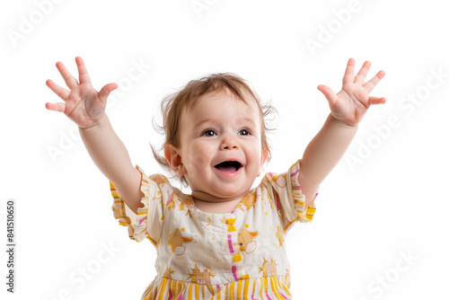 A happy toddler is expressing pure joy, raising arms in celebration with a big smile on their face photo
