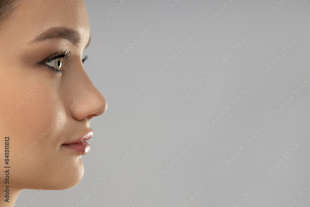 Attractive young girl on a gray background. Botox concept Attractive young girl on a gray background. Botox concept