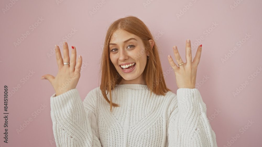 Smiling young caucasian woman gesturing number nine with her fingers over a pink background. Smiling young caucasian woman gesturing number nine with her fingers over a pink background.