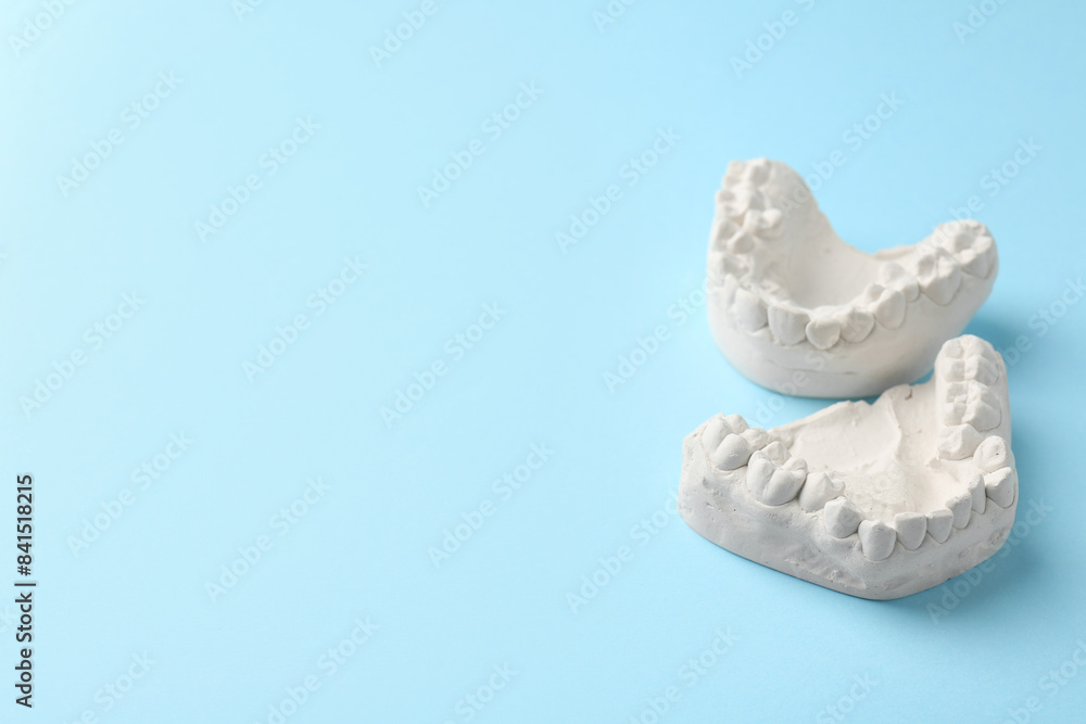 Obraz premium Dental model with gums on light blue background, space for text. Cast of teeth