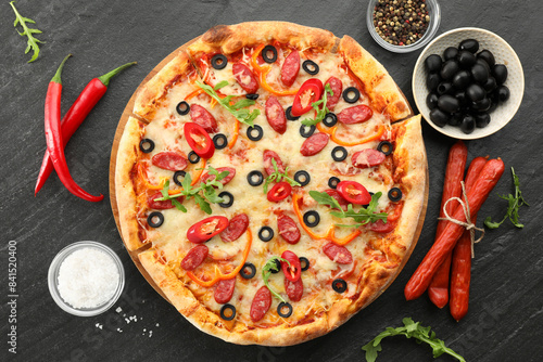 Tasty pizza and ingredients on grey table, top view