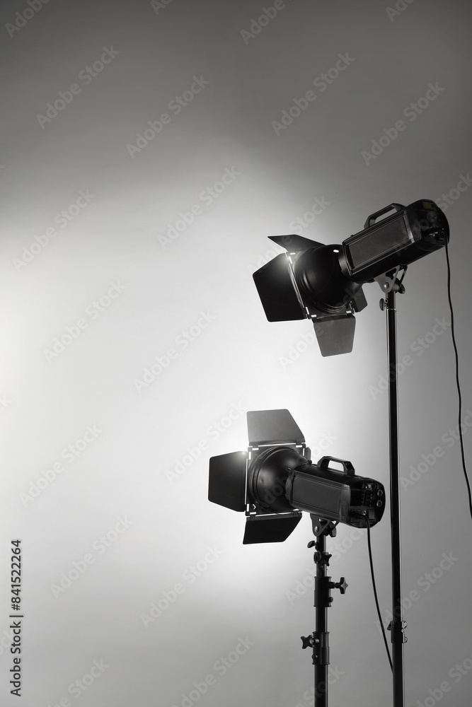 Grey photo background and professional lighting equipment in studio Grey photo background and professional lighting equipment in studio