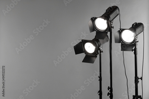 Grey photo background and professional lighting equipment in studio. Space for text © New Africa