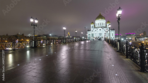 Majestic orthodox Cathedral of Christ Saviour illuminated at dusk on bank of Moscow river. Timelapse, Russia