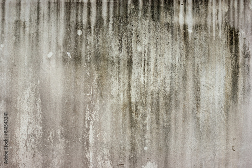 black mold indicating damp on outside white cement wall.