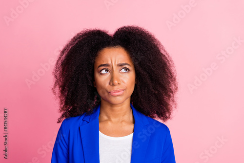 Photo of puzzled confused woman with perming coiffure wear blue jacket look at proposition empty space isolated on pink color background