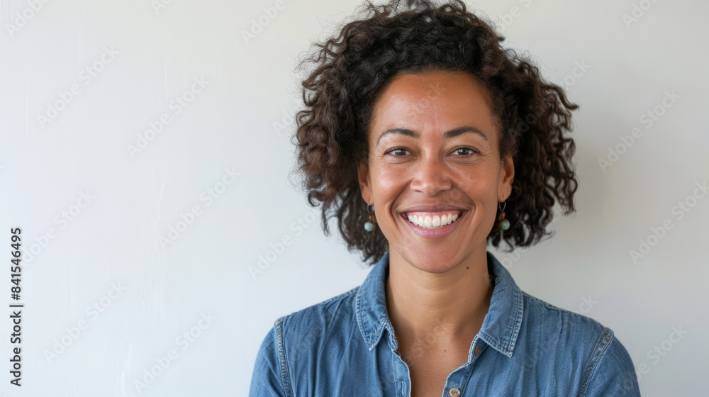 Portrait of smiling mid adult woman in casual denim shirt Portrait of smiling mid adult woman in casual denim shirt