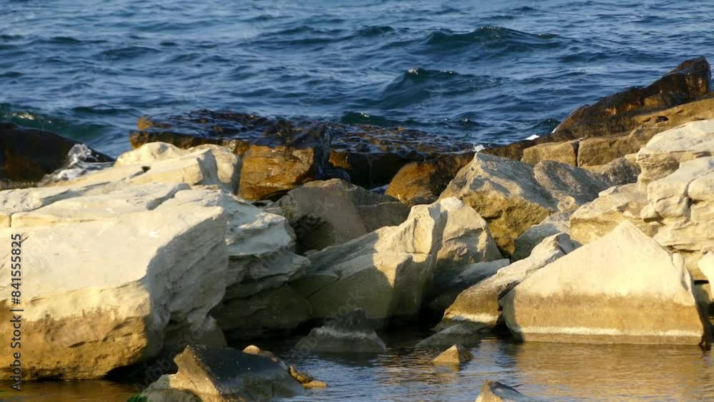 Waves breaking on rocks at coast of sea Waves breaking on rocks at coast of sea