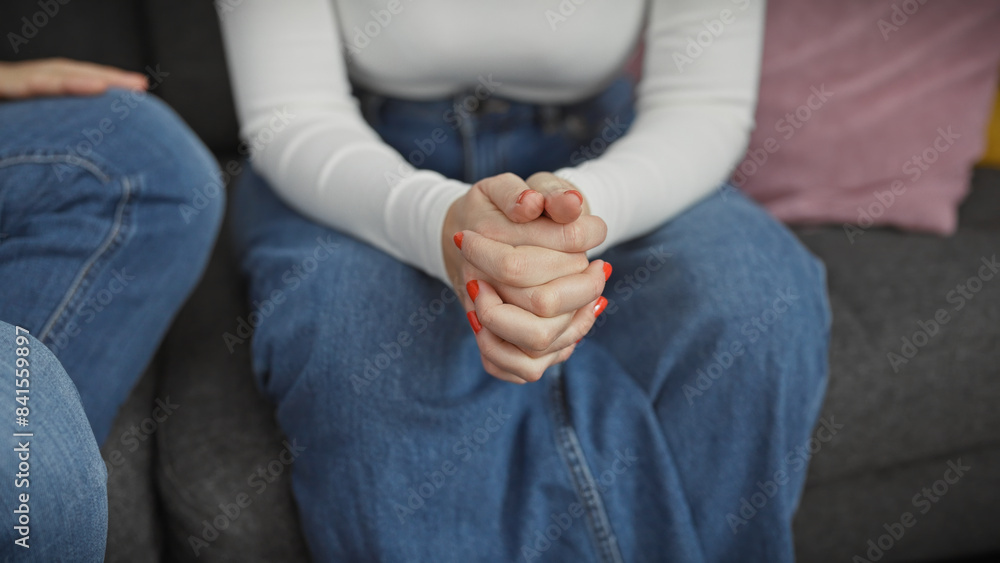Close-up of intertwined hands of a man and woman, signaling love and support in a cozy home environment. Close-up of intertwined hands of a man and woman, signaling love and support in a cozy home environment.