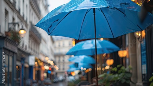 A Blue Umbrella Under Parisian Streetlights