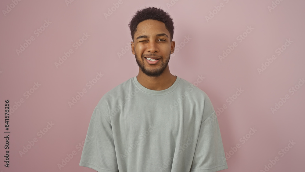 Portrait of a smiling african american man isolated against a pink background, exuding confidence and approachability. Portrait of a smiling african american man isolated against a pink background, exuding confidence and approachability.