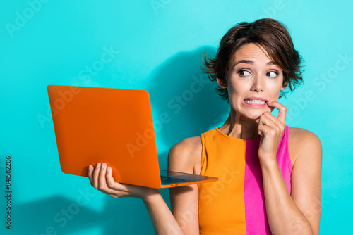 Photo of impressed guilty woman wear pink orange top having working problem modern gadget isolated teal color background