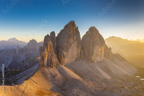 Dolomites beautiful alpine rock tower summits under blue sky in summer. Italian Alps mountains scenic landscape of rocky climbing walls in the high altitude majestic view of the cliff and green valley
