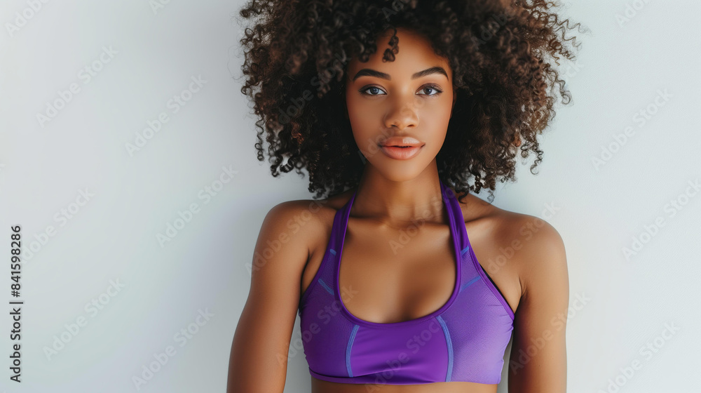 African American woman posing confidently, wearing a vibrant purple sports crop top and leopard print leggings, white background African American woman posing confidently, wearing a vibrant purple sports crop top and leopard print leggings, white background