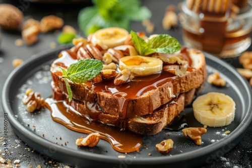 French toast with bananas, pecans, and caramel sauce served on a plate