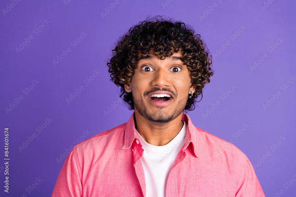 Portrait of nice young man open mouth wear pink shirt isolated on purple color background Portrait of nice young man open mouth wear pink shirt isolated on purple color background
