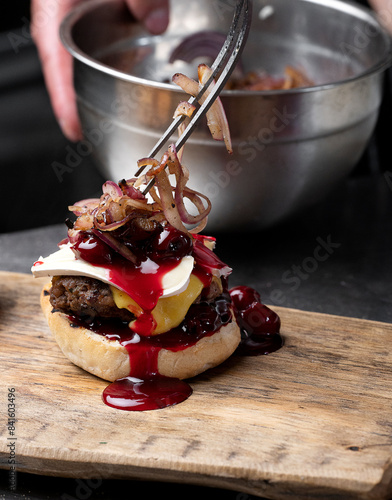 Preparation of burger. Professional chef is preparing burger. Burger making. Cooking hamburger concept.