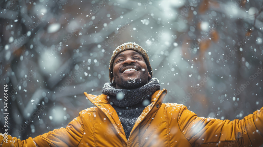 Portrait of a happy African man freely open his arms and enjoys the nature, winter snowy cold day outdoors Portrait of a happy African man freely open his arms and enjoys the nature, winter snowy cold day outdoors
