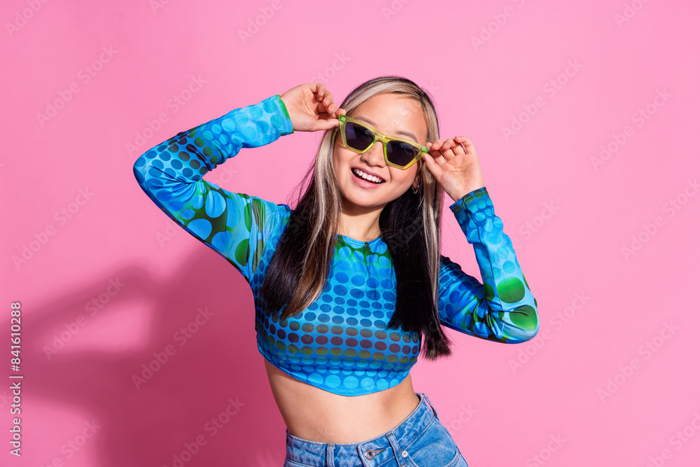 Photo of shiny attractive lady dressed print shirt dark eyewear smiling empty space isolated pink color background Photo of shiny attractive lady dressed print shirt dark eyewear smiling empty space isolated pink color background