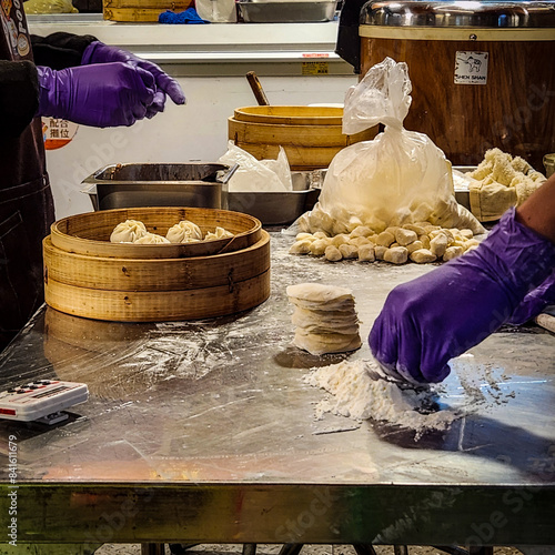 Making a xiaolongbao in a street market in Taipei Taiwan. photo