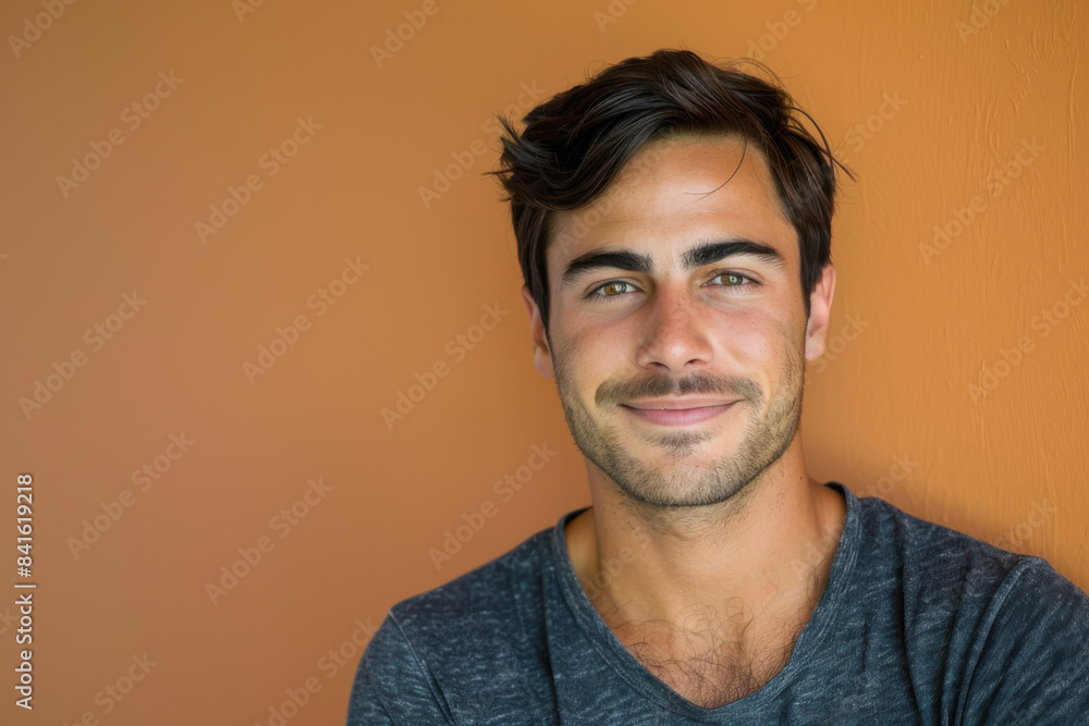A close up portrait of a young man with a subtle smile A close up portrait of a young man with a subtle smile