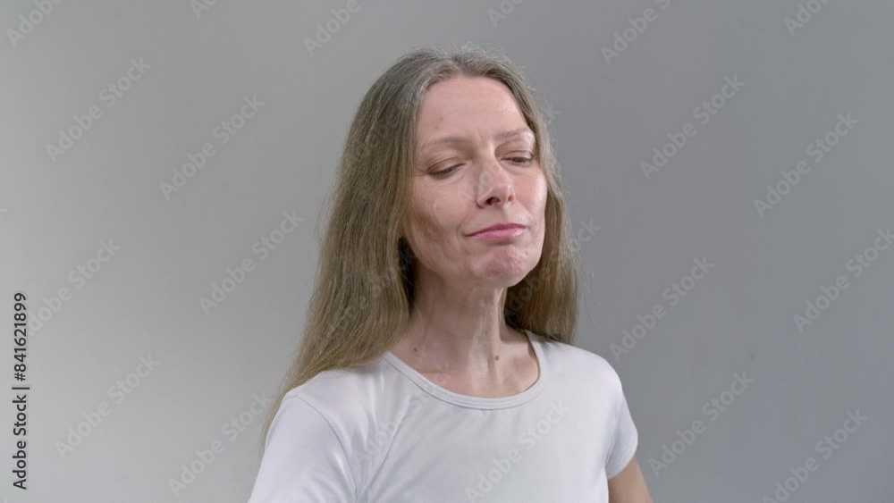 Old Caucasian woman drinking water, studio shot. The senior female holds a glass of water in her hand. Mature Retirement, elderly lady hydrating body with clean filtered fresh mineral water Old Caucasian woman drinking water, studio shot. The senior female holds a glass of water in her hand. Mature Retirement, elderly lady hydrating body with clean filtered fresh mineral water