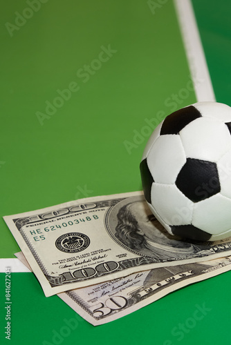 Schilderij op canvas Soccer ball and dollars on green background, favorite soccer predictions, bookma