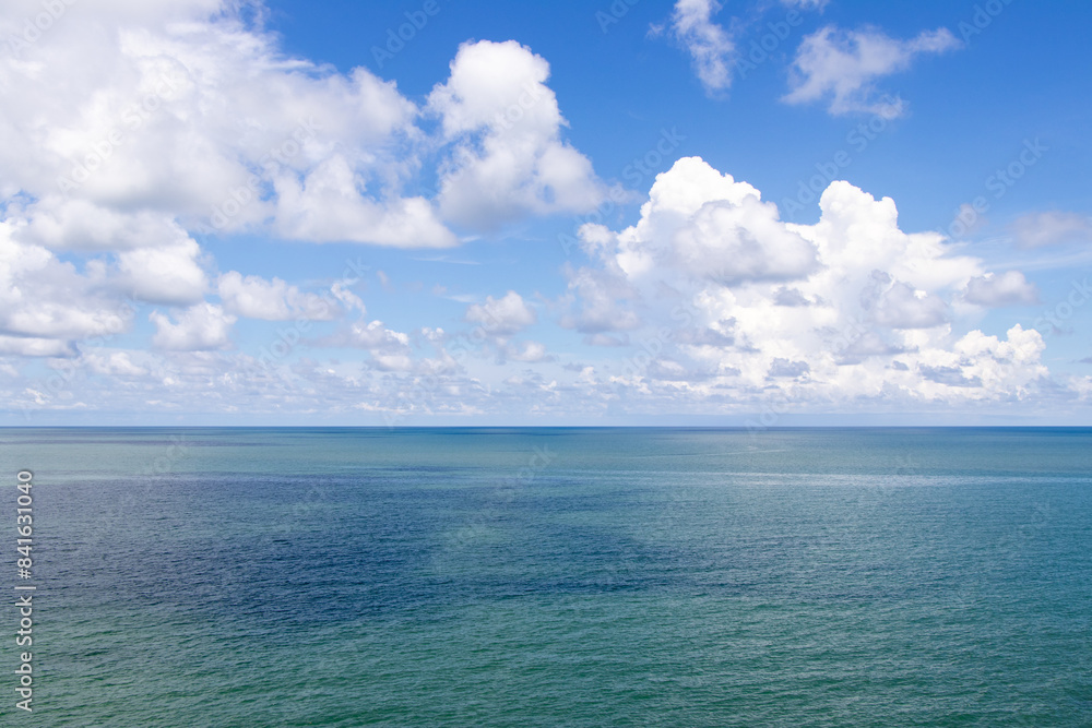 Beautiful calm turquoise color sea and blue sky with white color cloud background Beautiful calm turquoise color sea and blue sky with white color cloud background