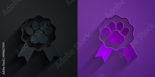 Paper cut Pet award symbol icon isolated on black on purple background. Badge with dog or cat paw print and ribbons. Medal for animal. Paper art style. Vector