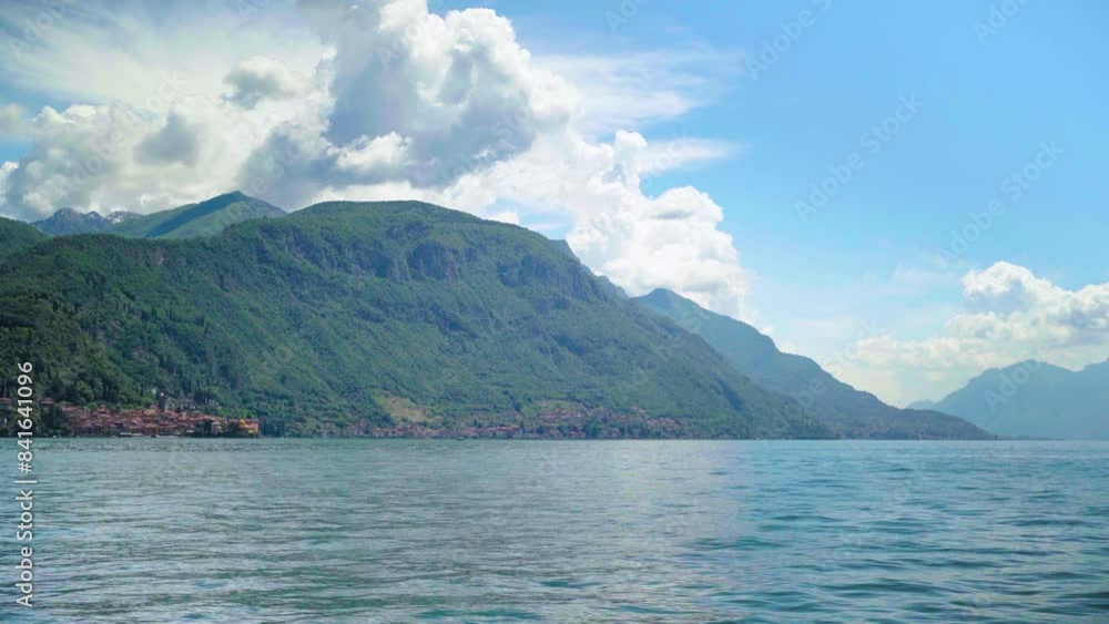Small villages at Italian Mountains next to Lake with clouds and alps Small villages at Italian Mountains next to Lake with clouds and alps
