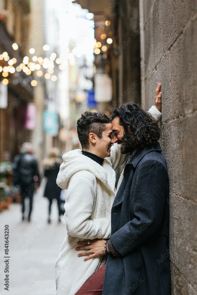 Loving gay couple embracing on city street Loving gay couple embracing on city street