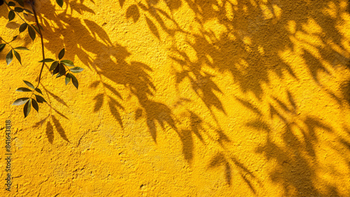 Shadow of leaves on yellow concrete wall texture with roughness and irregularities. Abstract trendy colored nature concept background. Copy space for text overlay, poster mockup flat lay