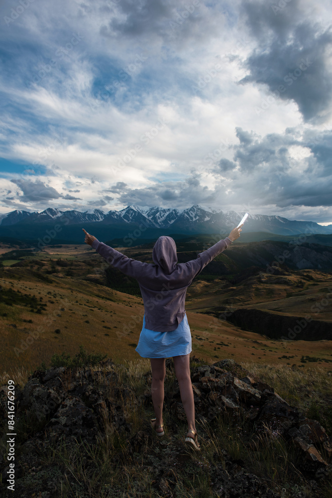 Woman with flashlight in summer Altai mountains in Kurai steppe Woman with flashlight in summer Altai mountains in Kurai steppe
