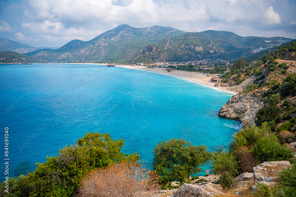 Aerial view of Oludeniz beach with people and boats in the morning, Coastline next to Fethiye, Turkey Aerial view of Oludeniz beach with people and boats in the morning, Coastline next to Fethiye, Turkey