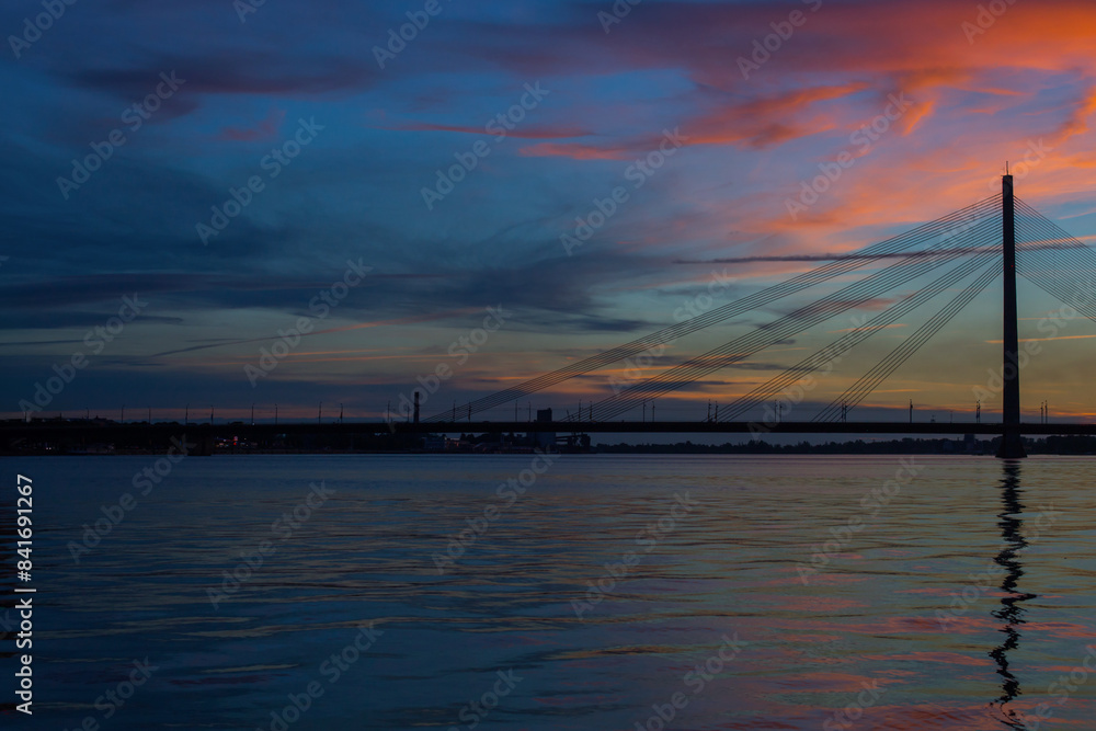 modern suspension bridge over the river at sunset modern suspension bridge over the river at sunset