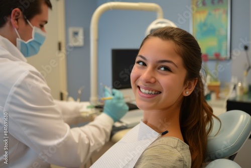 Smiling Woman Receiving Routine Dental Checkup in Modern Clinic Setting