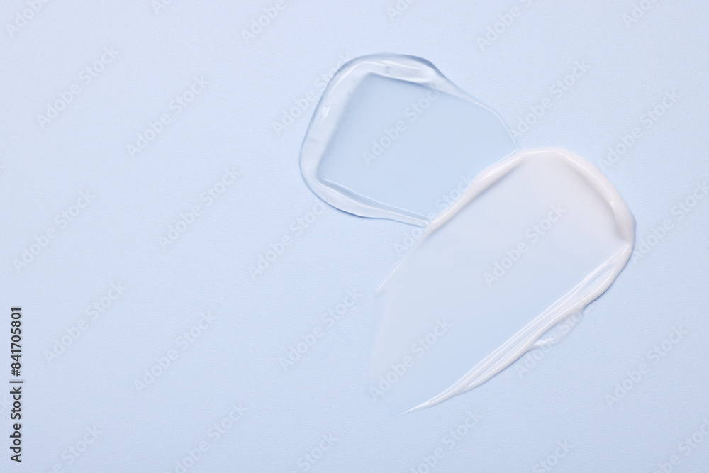 Samples of face cream on light blue background, top view. Space for text Samples of face cream on light blue background, top view. Space for text